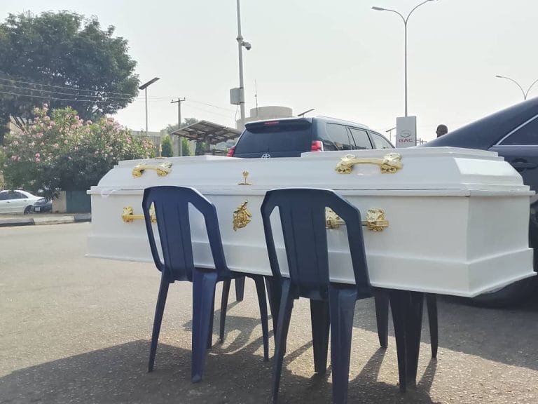 Contractors lay coffin in front of Finance Ministry
