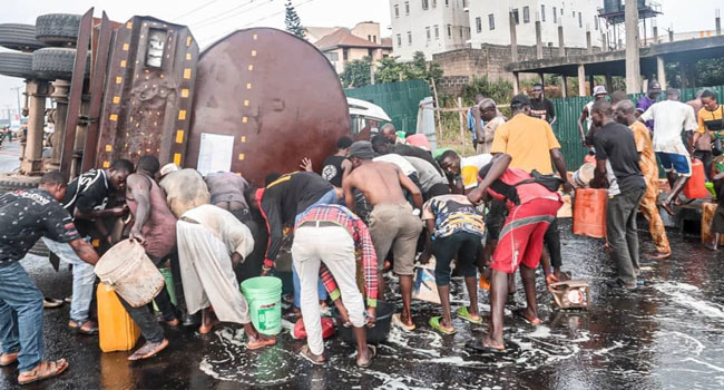 Days after nearly 100 were roasted, youths scoop fuel from fallen tanker in Jalingo